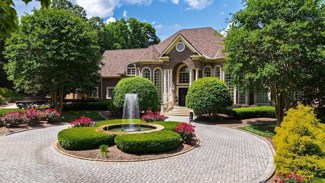 2421 Acanthus Dr, Wake Forest, NC 27587 - georgian-style home featuring curved driveway and brick siding