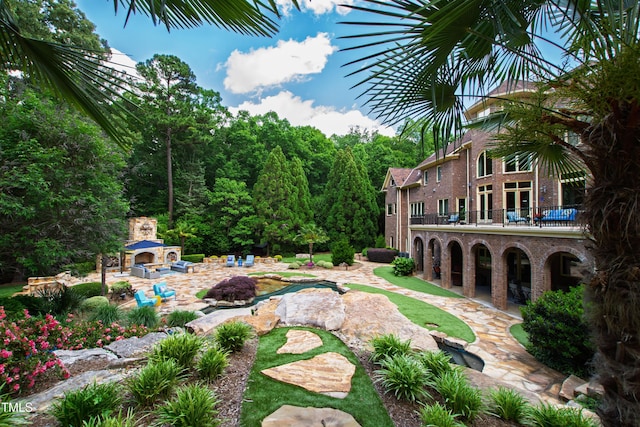 2421 Acanthus Dr, Wake Forest, NC 27587 - view of yard featuring a fireplace and a patio