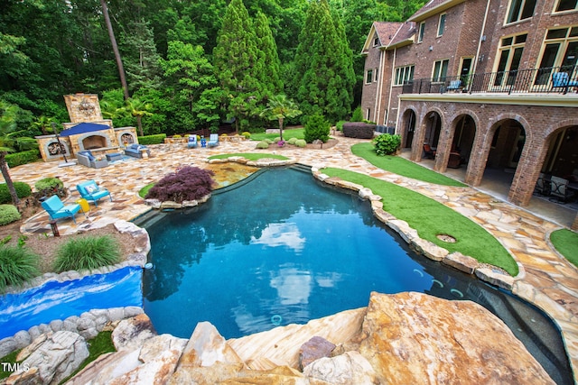 2421 Acanthus Dr, Wake Forest, NC 27587 - swimming pool featuring an outdoor fireplace and a patio