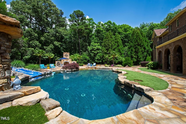 2421 Acanthus Dr, Wake Forest, NC 27587 - swimming pool with an outdoor stone fireplace and a patio