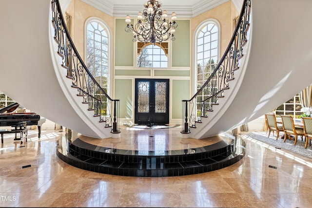 2421 Acanthus Dr, Wake Forest, NC 27587 - foyer entrance featuring french doors, a chandelier, stairway, crown molding, and a towering ceiling