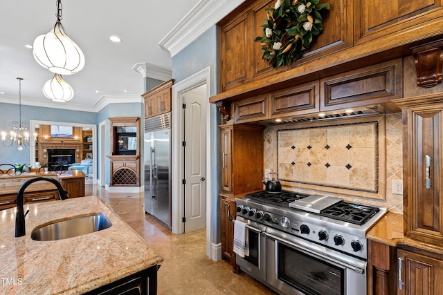2421 Acanthus Dr, Wake Forest, NC 27587 - kitchen with premium appliances, a sink, light stone counters, pendant lighting, and recessed lighting
