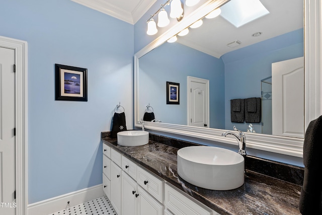 2421 Acanthus Dr, Wake Forest, NC 27587 - full bath featuring ornamental molding, double vanity, a skylight, and baseboards