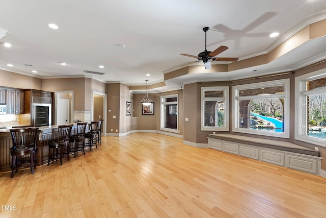2421 Acanthus Dr, Wake Forest, NC 27587 - living room featuring light wood finished floors, a ceiling fan, crown molding, recessed lighting, and baseboards