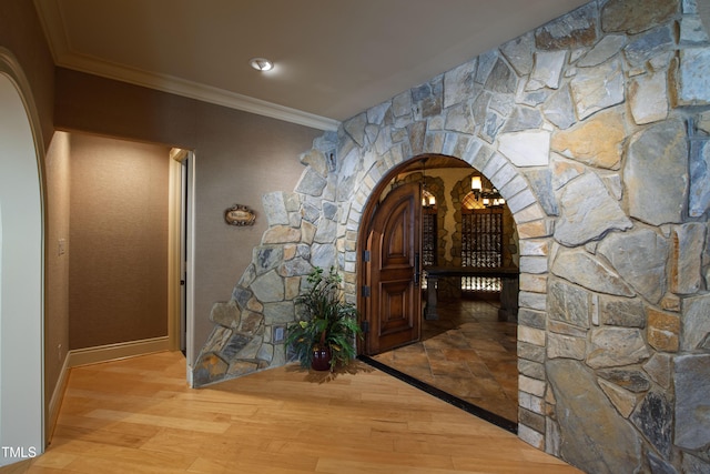 2421 Acanthus Dr, Wake Forest, NC 27587 - hall with arched walkways, crown molding, and light wood-style floors
