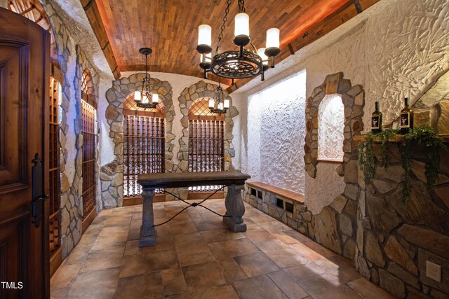 2421 Acanthus Dr, Wake Forest, NC 27587 - wine room featuring a chandelier, stone finish floors, lofted ceiling, and wooden ceiling