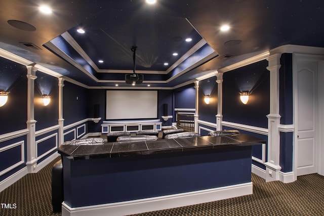 2421 Acanthus Dr, Wake Forest, NC 27587 - cinema room featuring dark colored carpet, a decorative wall, a raised ceiling, ornamental molding, and wainscoting