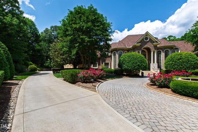 2421 Acanthus Dr, Wake Forest, NC 27587 - view of front of house with curved driveway and brick siding