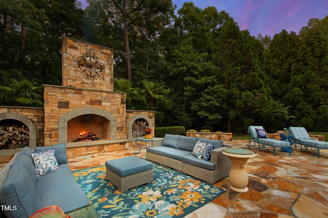 2421 Acanthus Dr, Wake Forest, NC 27587 - patio terrace at dusk featuring an outdoor living space with a fireplace and a patio area