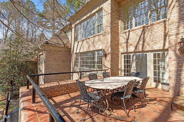 deck with french doors and outdoor dining area