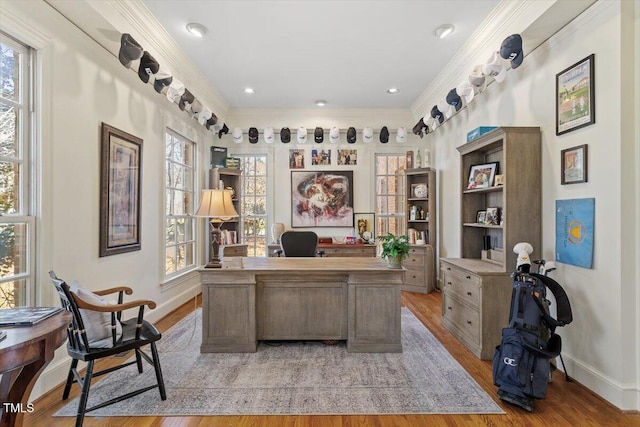 office featuring light wood-style flooring, crown molding, and baseboards