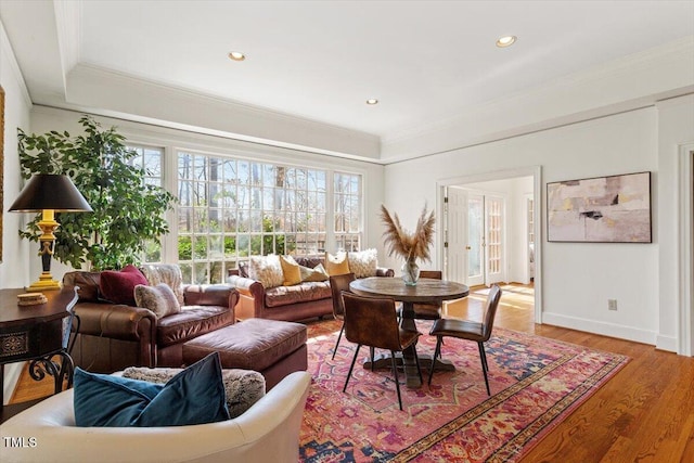 living area with crown molding, recessed lighting, wood finished floors, and baseboards