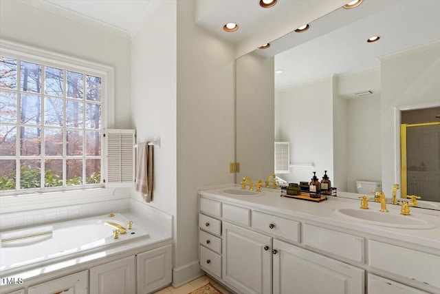 full bathroom with ornamental molding, toilet, a garden tub, and a sink