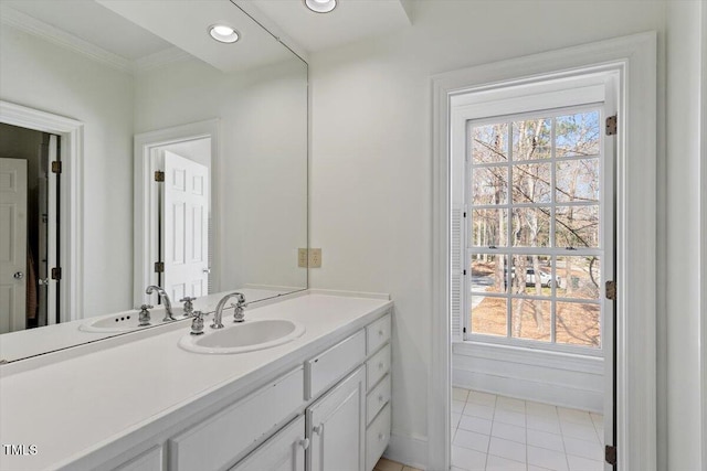 bathroom featuring recessed lighting, vanity, baseboards, and ornamental molding