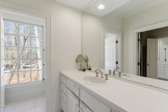 bathroom featuring vanity, baseboards, recessed lighting, ornamental molding, and tile patterned floors