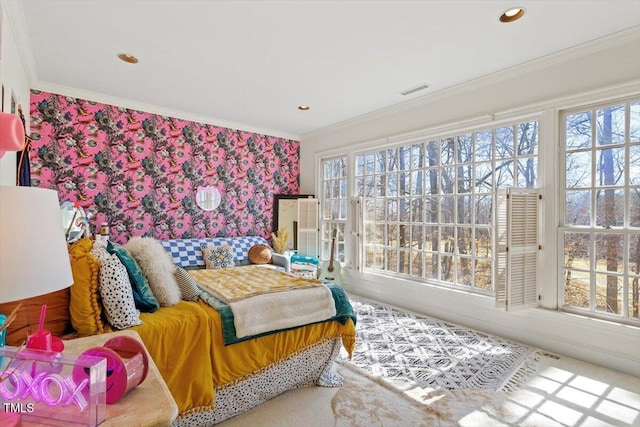 bedroom featuring multiple windows, wallpapered walls, and crown molding