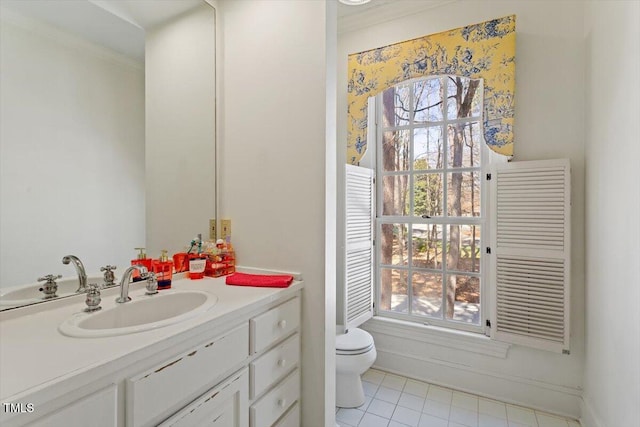 bathroom with baseboards, toilet, and vanity