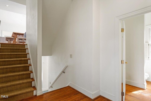 stairs with baseboards and wood finished floors