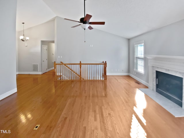 unfurnished living room with light wood-style floors, visible vents, and baseboards