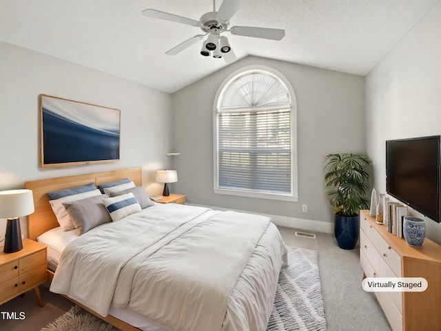 carpeted bedroom with vaulted ceiling, a ceiling fan, visible vents, and baseboards