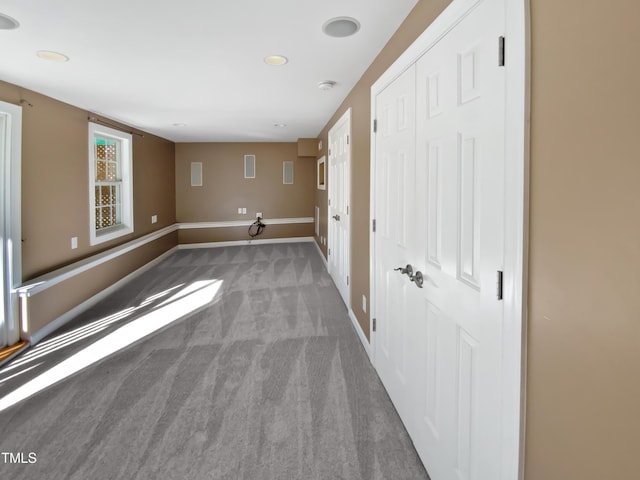 empty room featuring baseboards and carpet floors