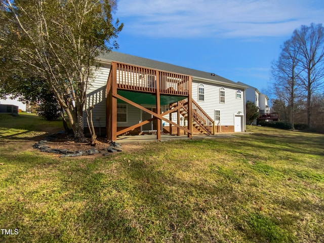 back of property featuring crawl space, stairway, a lawn, and a wooden deck