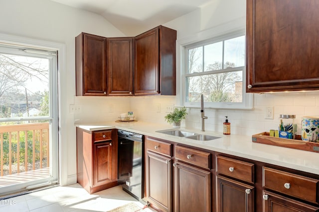 kitchen with a sink, tasteful backsplash, dishwasher, and light countertops