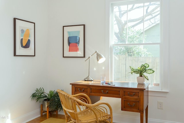 home office with wood finished floors and baseboards