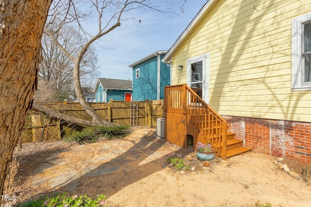 exterior space featuring central air condition unit and fence