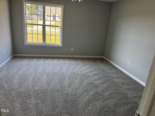 unfurnished room featuring baseboards and carpet floors