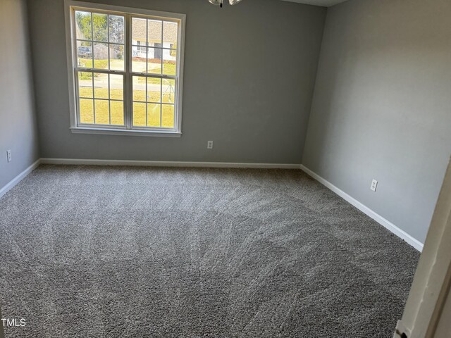 empty room with baseboards and carpet