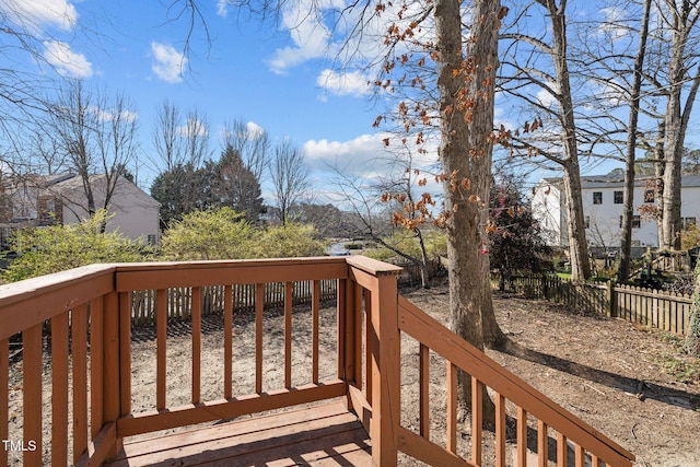 wooden terrace featuring fence