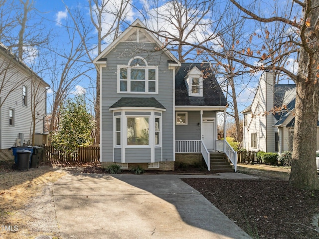 view of front of property featuring crawl space, roof with shingles, and fence