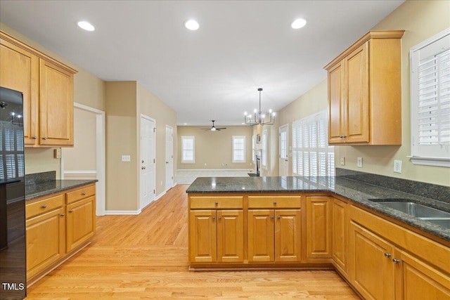 kitchen featuring a peninsula, light wood-style flooring, recessed lighting, and a wealth of natural light