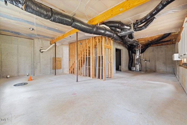 unfinished basement featuring heating unit