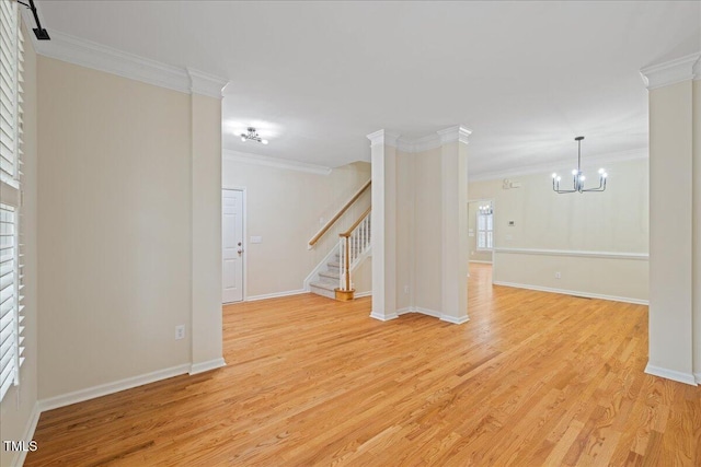 interior space featuring baseboards, crown molding, stairs, and light wood finished floors