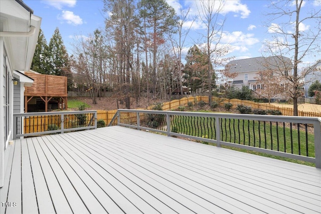 deck with a lawn and fence