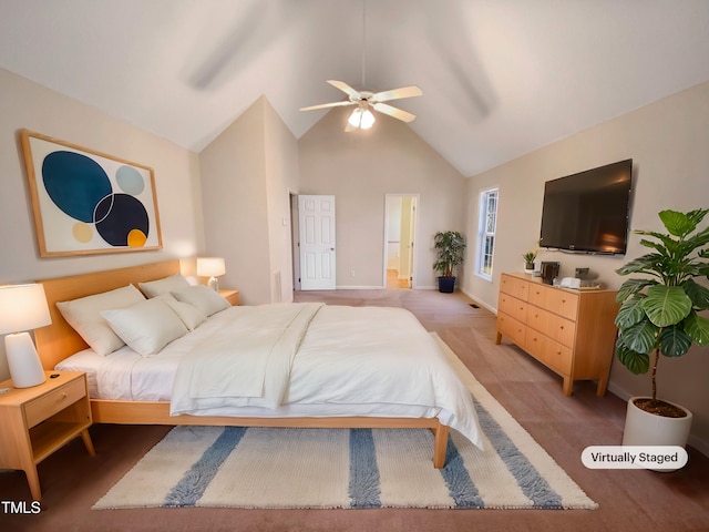 bedroom featuring ceiling fan, ensuite bath, baseboards, and high vaulted ceiling