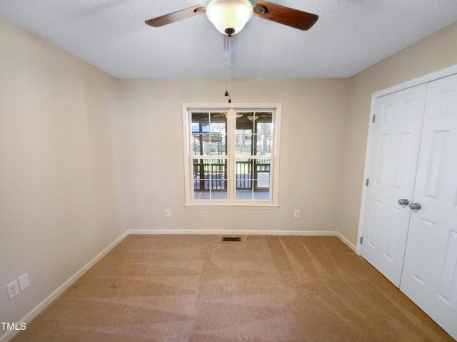 unfurnished bedroom with light carpet, baseboards, visible vents, and a textured ceiling