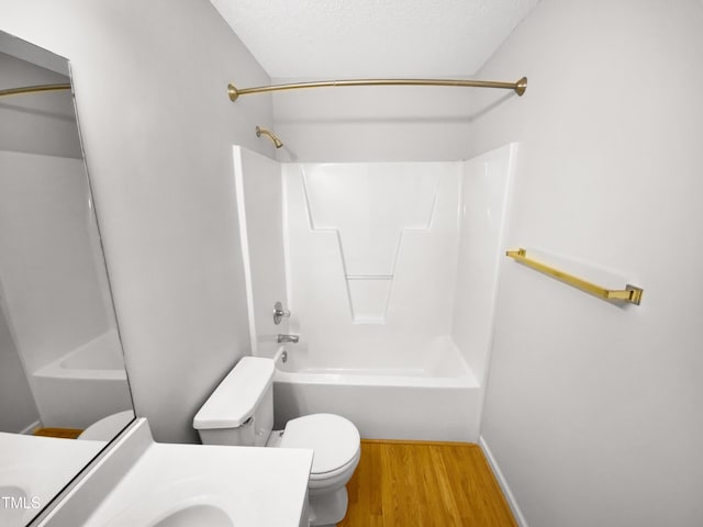 bathroom with toilet, a textured ceiling, shower / tub combination, wood finished floors, and vanity