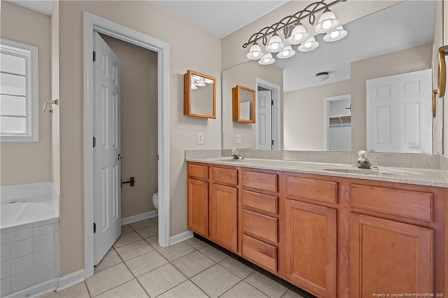 bathroom featuring a sink, toilet, double vanity, and tile patterned flooring