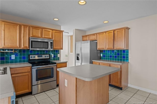 kitchen with a kitchen island, stainless steel appliances, light countertops, light tile patterned floors, and decorative backsplash