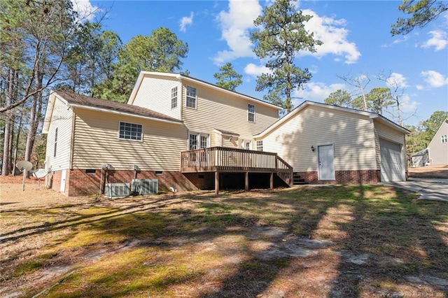 back of property with central air condition unit, a wooden deck, a lawn, a garage, and crawl space