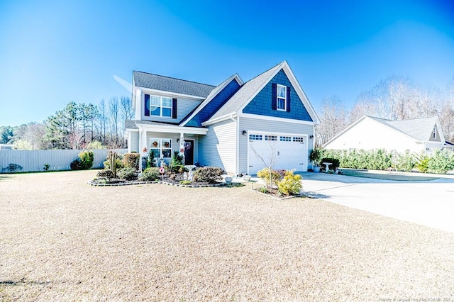 view of front of property with concrete driveway and fence