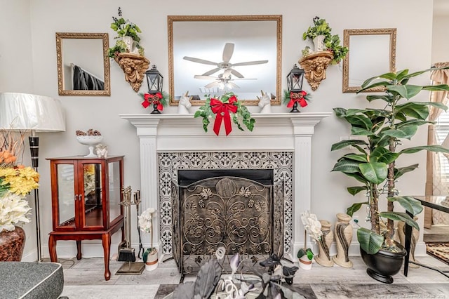 room details with a fireplace, baseboards, and ceiling fan