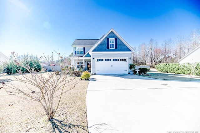 craftsman-style home featuring concrete driveway