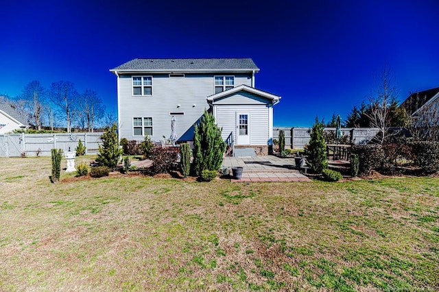 back of house featuring a patio, a lawn, and a fenced backyard