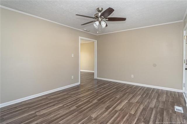 spare room with visible vents, baseboards, dark wood-style flooring, and crown molding