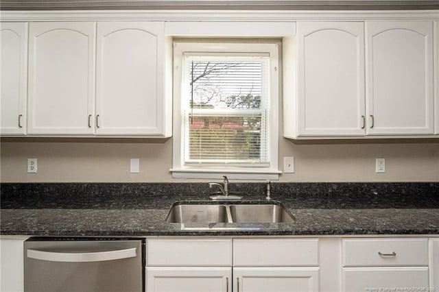 kitchen featuring a sink, stainless steel dishwasher, white cabinets, and dark stone countertops