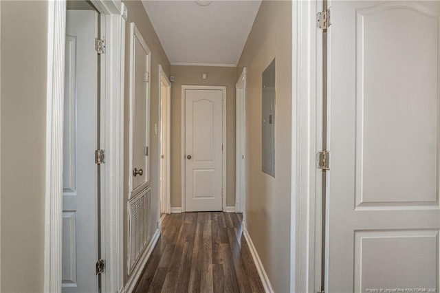 hallway featuring dark wood-style floors, visible vents, and baseboards